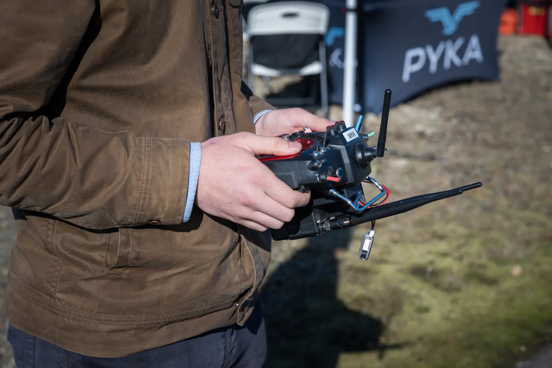 Operator hands on drone controller at Warfighter Ready field event