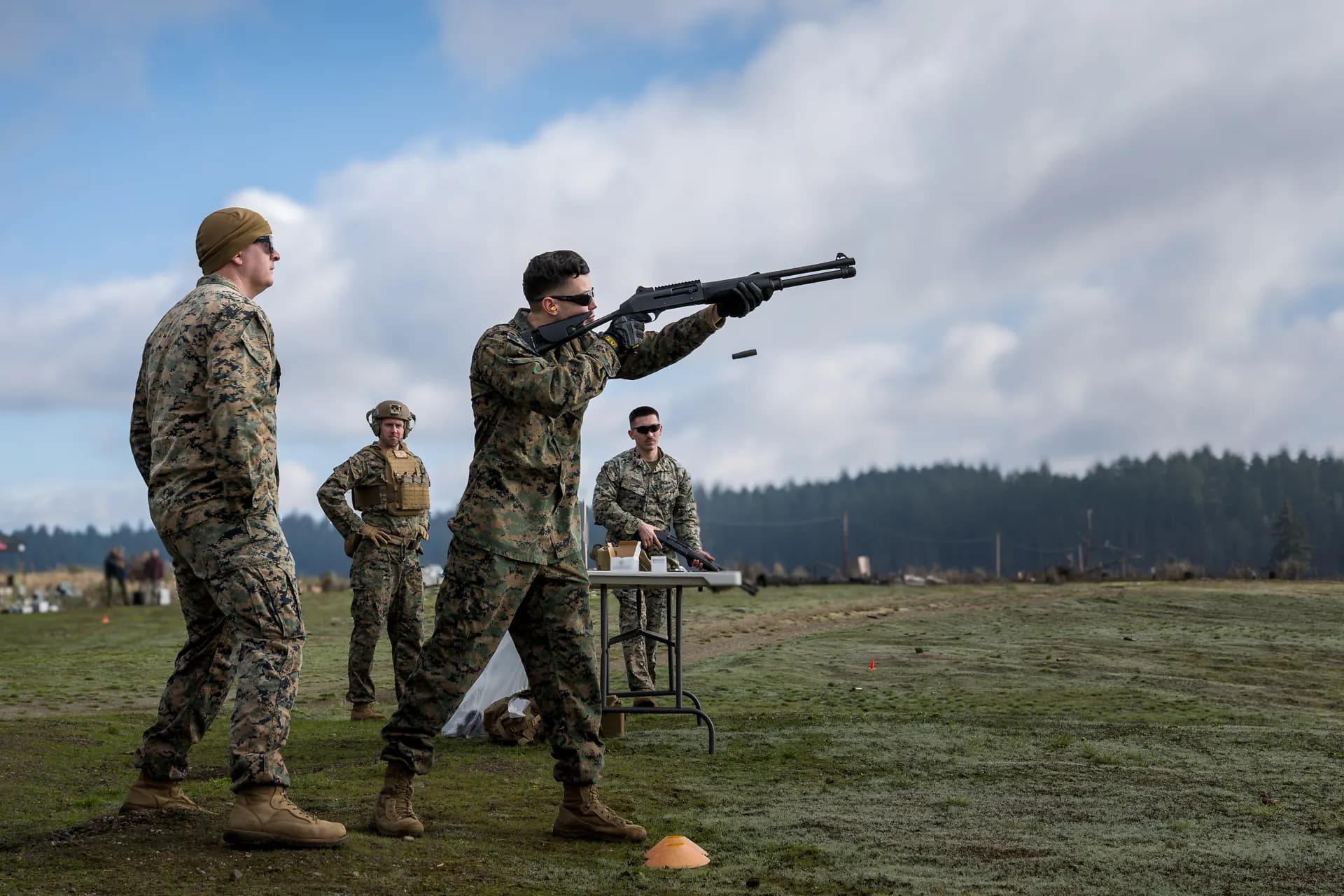 Marine firing shotgun at live fire range