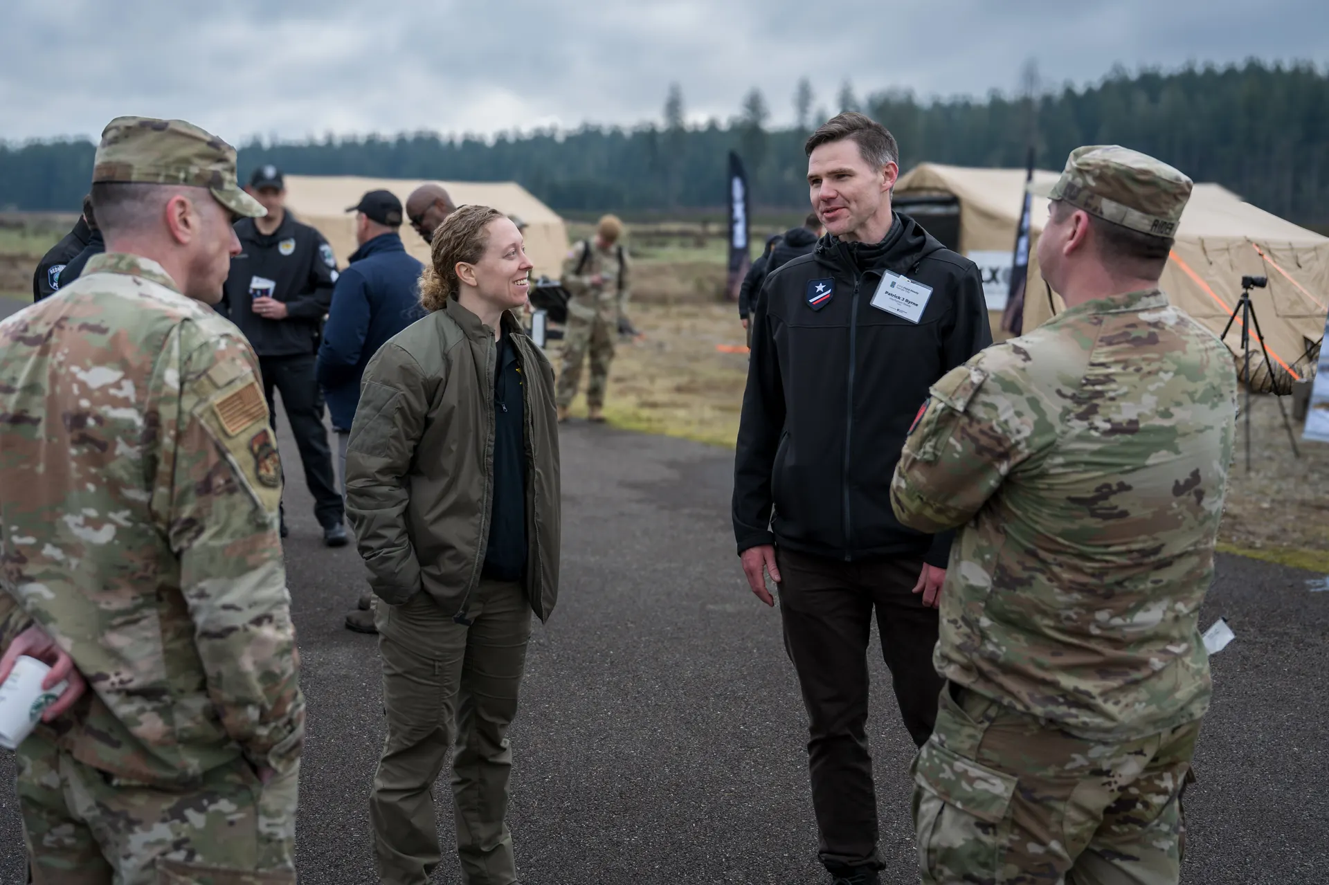 Warfighter Ready founder in conversation with U.S. Army officers at field event