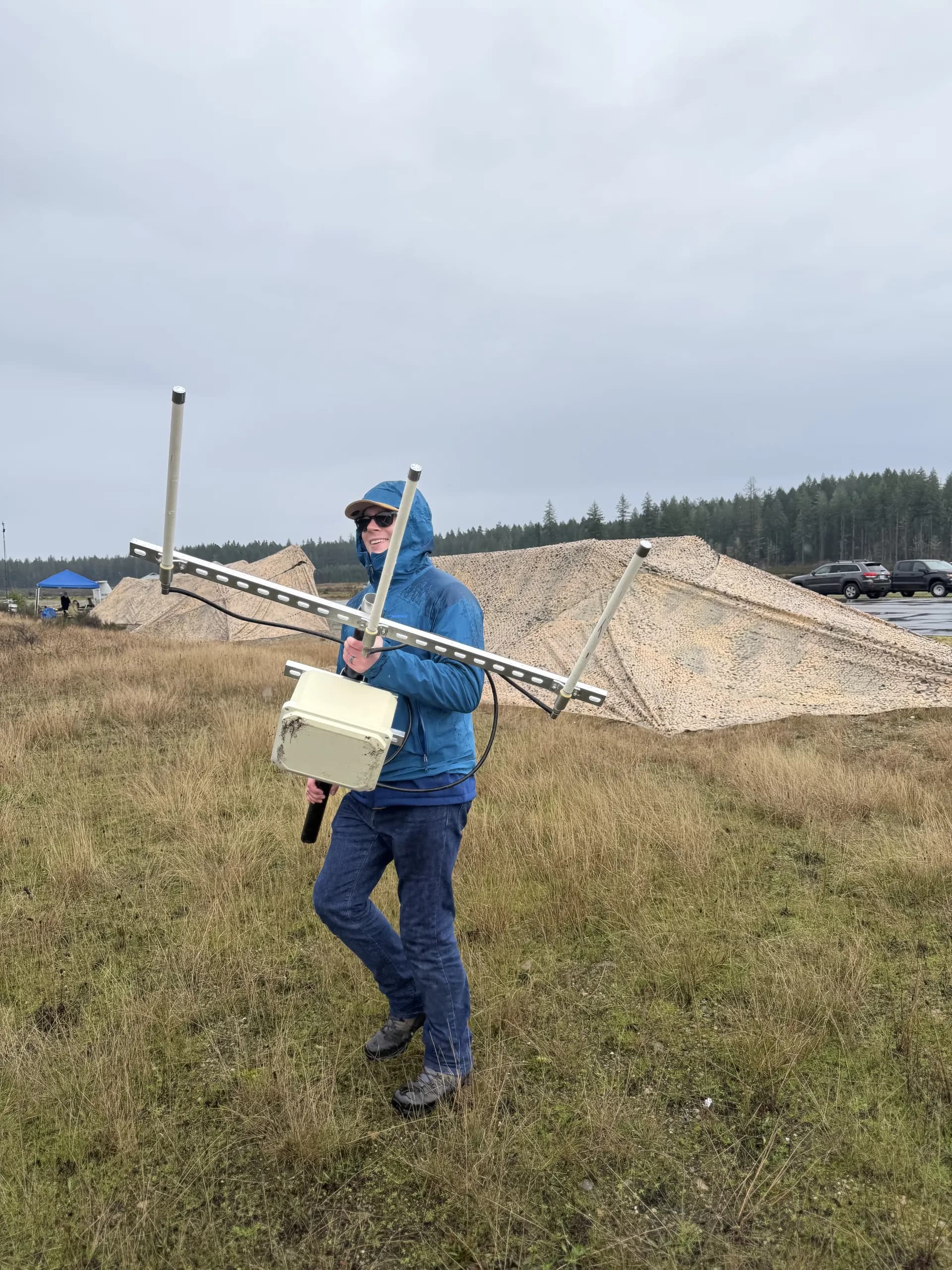 Person carrying antenna equipment in the field
