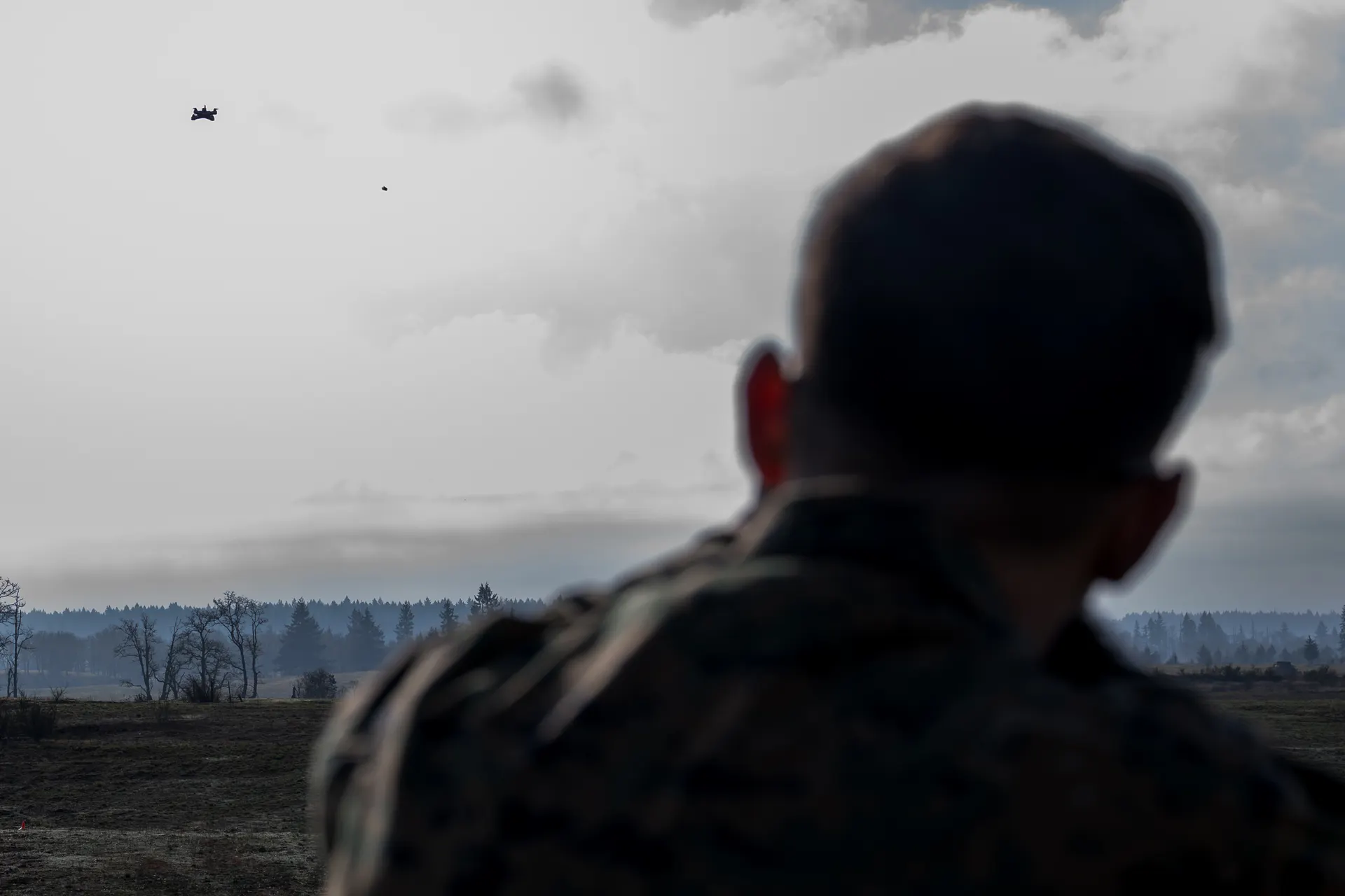 U.S. Army soldier observing drone during field demonstration