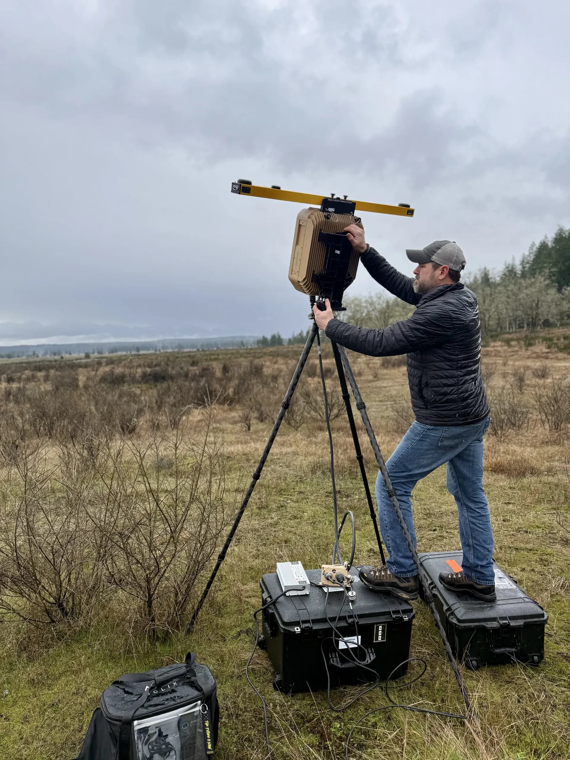 Vendor setting up radar antenna on tripod